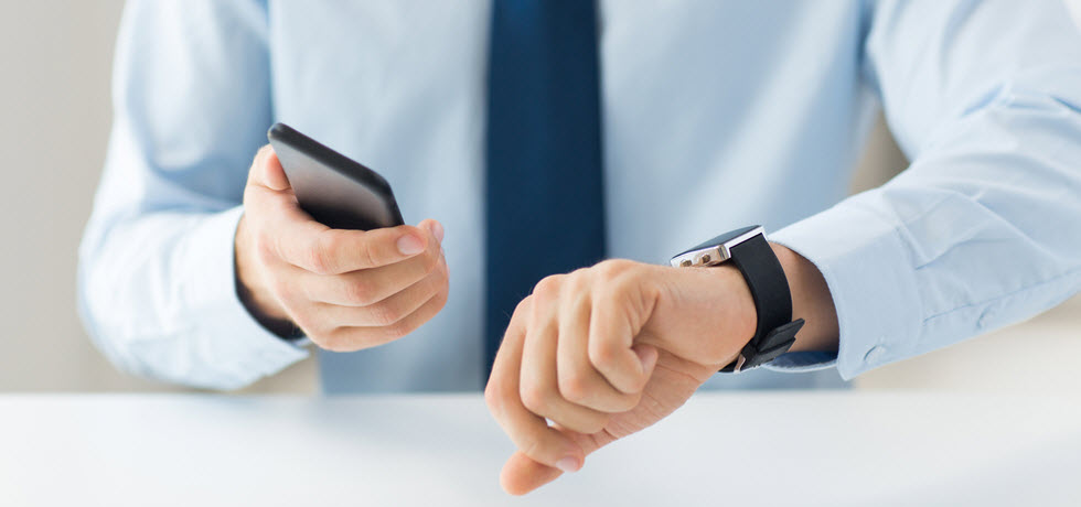 A man watching time and a mobile phone as the text message is delayed