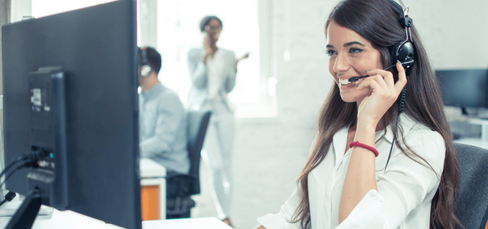 Image of a customer support agent answering an inquiry via telephone